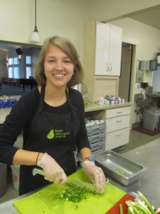 Grace busy in kitchen chopping green onions